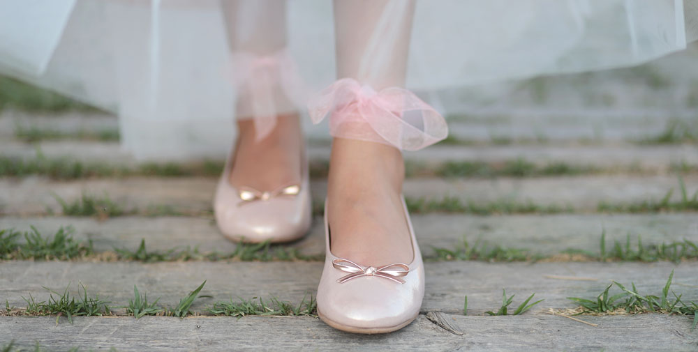 photo of a woman wearing stylish barefoot shoes with a dress